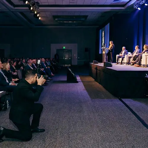 District Pixel photographer capturing a keynote speaker on stage during a corporate conference in Washington DC.