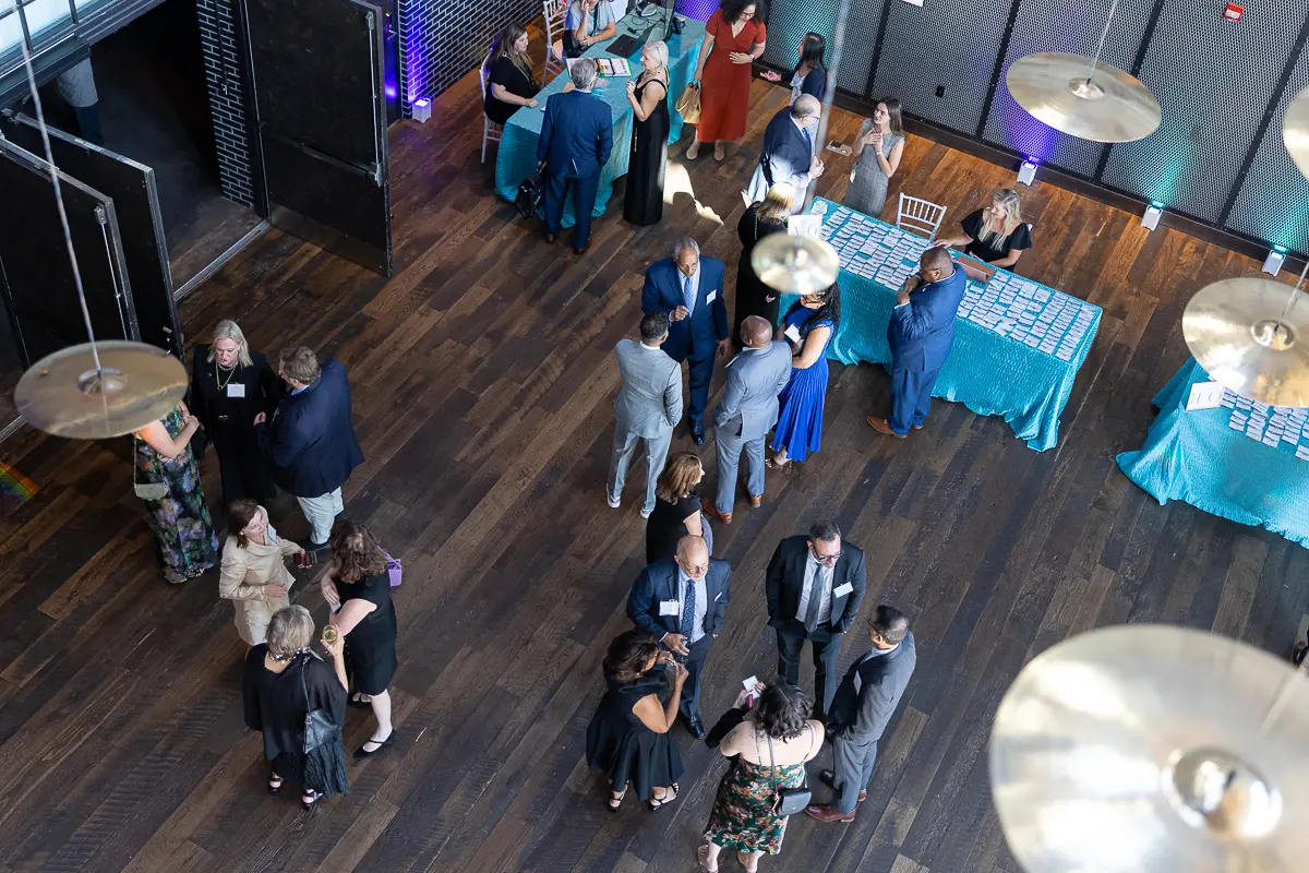 Overhead view of event registration and networking that requires planned corporate event photography coverage