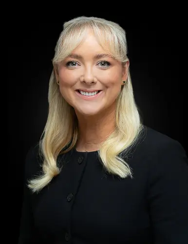 Professional corporate headshot of a woman photographed by District Pixel in Washington DC on a black background