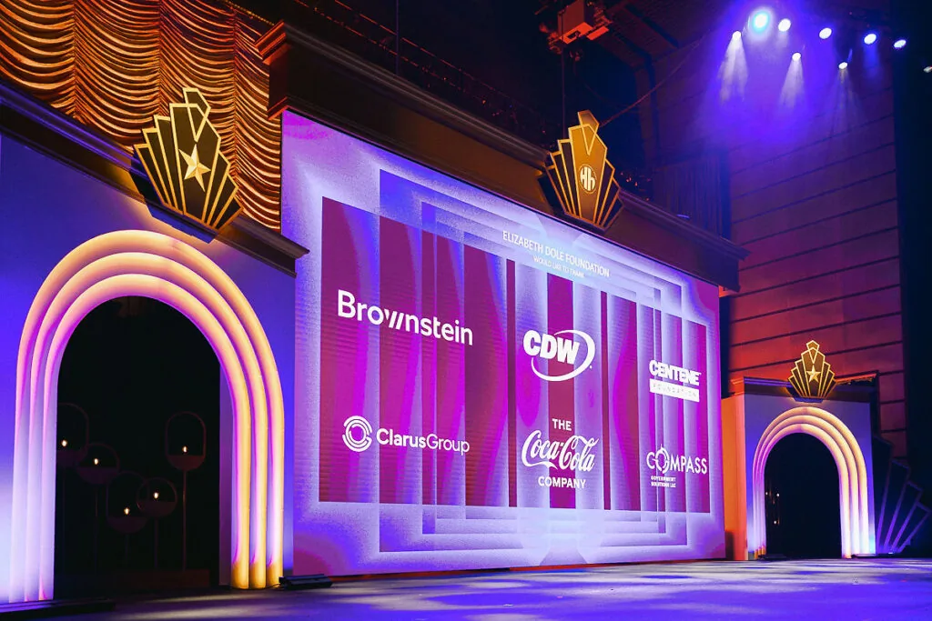 Branded gala stage design in Washington DC with sponsor logos, LED wall graphics, and executive event production