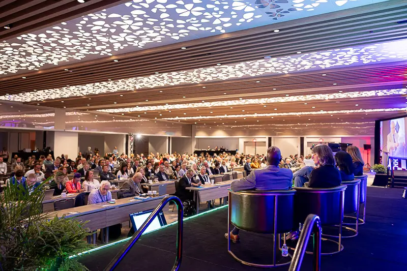 Panel discussion at a Washington DC professional conference with speakers seated on stage