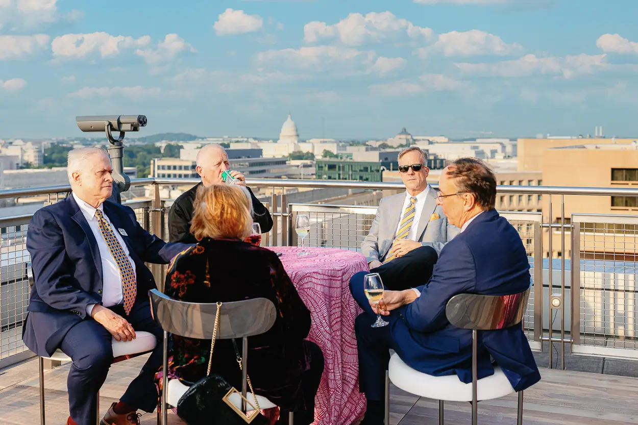 Executive networking moment at a Washington DC corporate event used for fast post-event recap communications