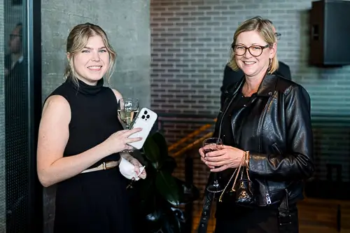 Two attendees smiling during a corporate networking reception in Washington DC