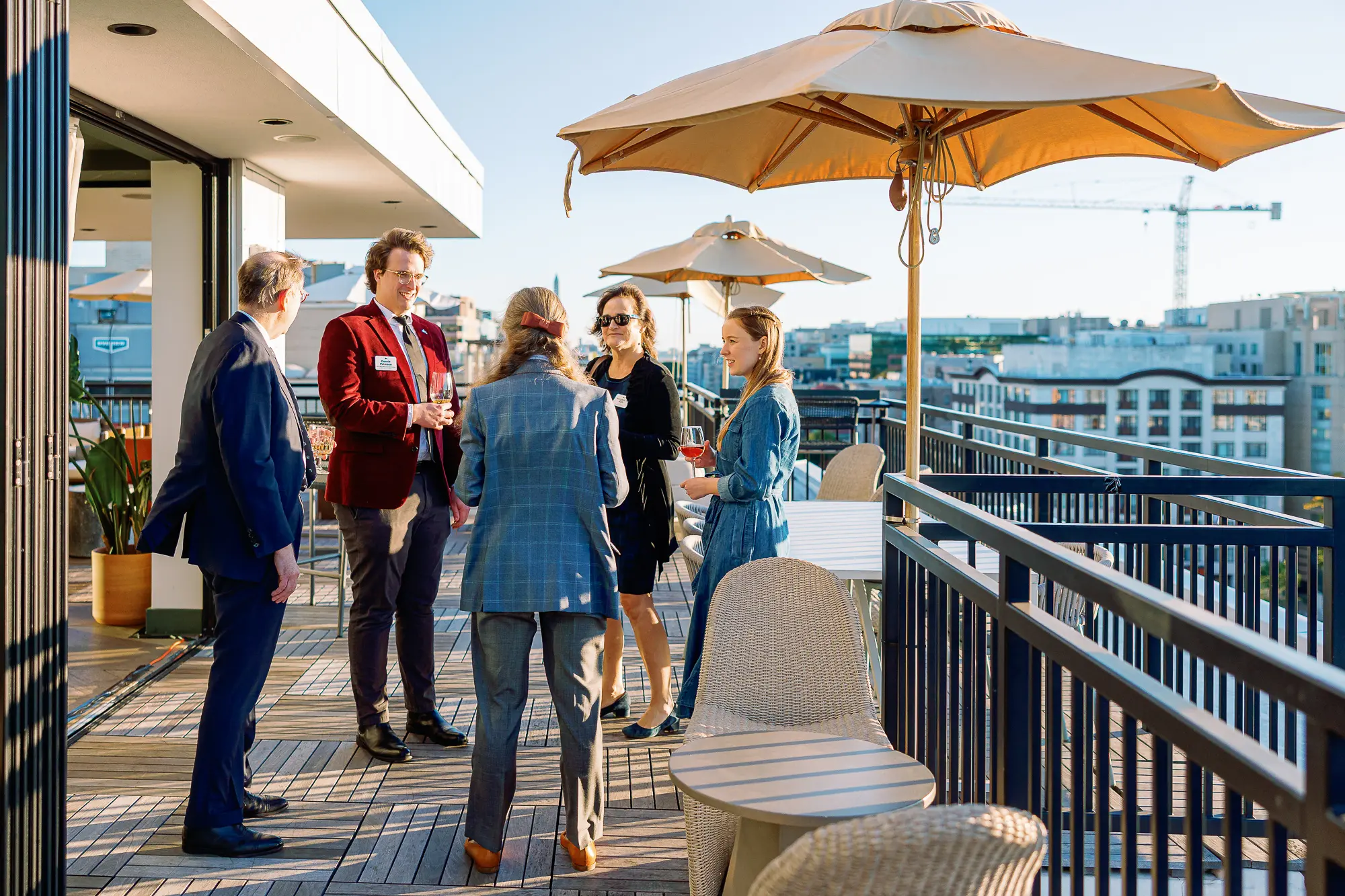 Corporate event guests networking on a rooftop terrace during a polished Washington DC reception