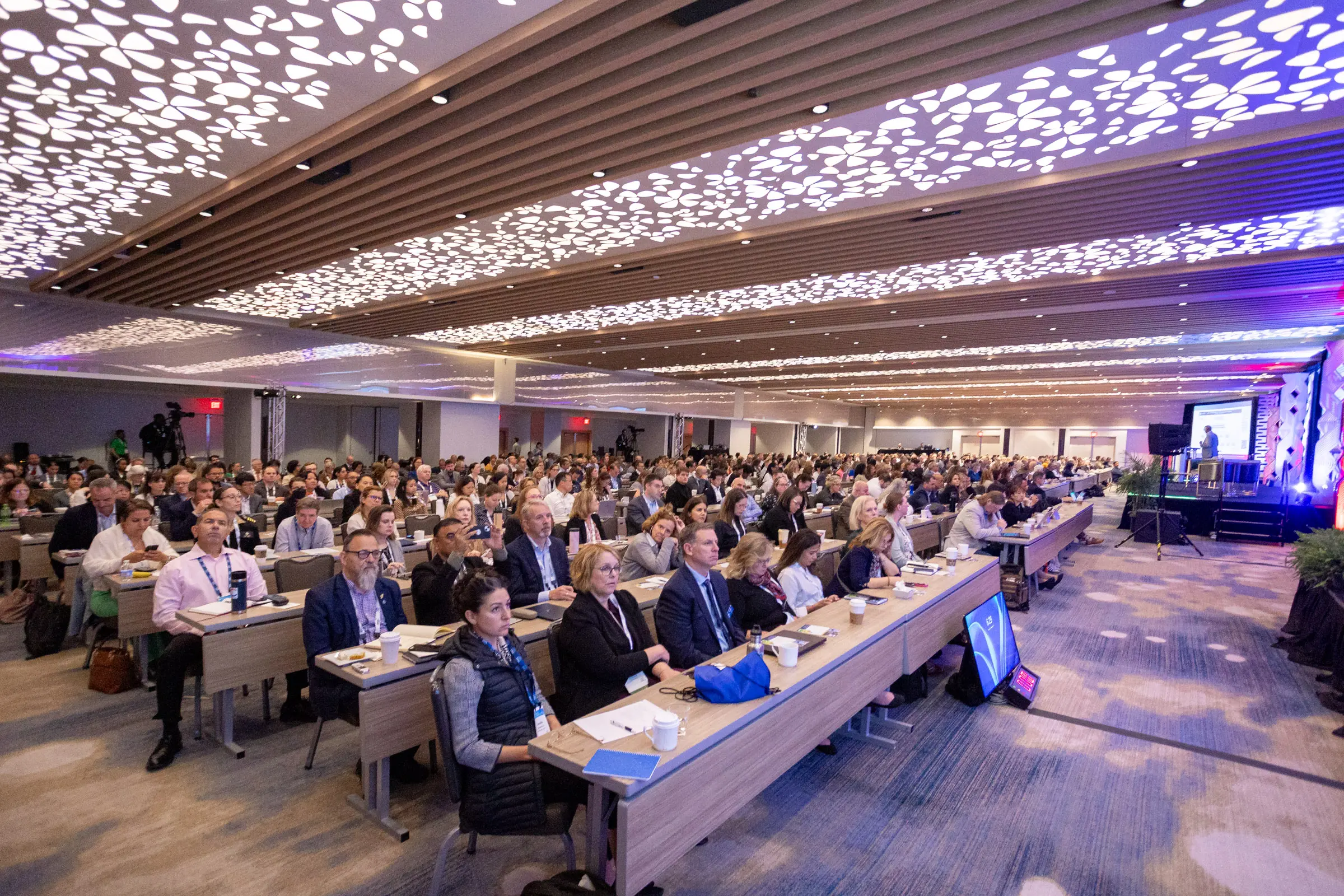 conference photographer Washington DC showing a large professional conference room with audience, stage, and event production