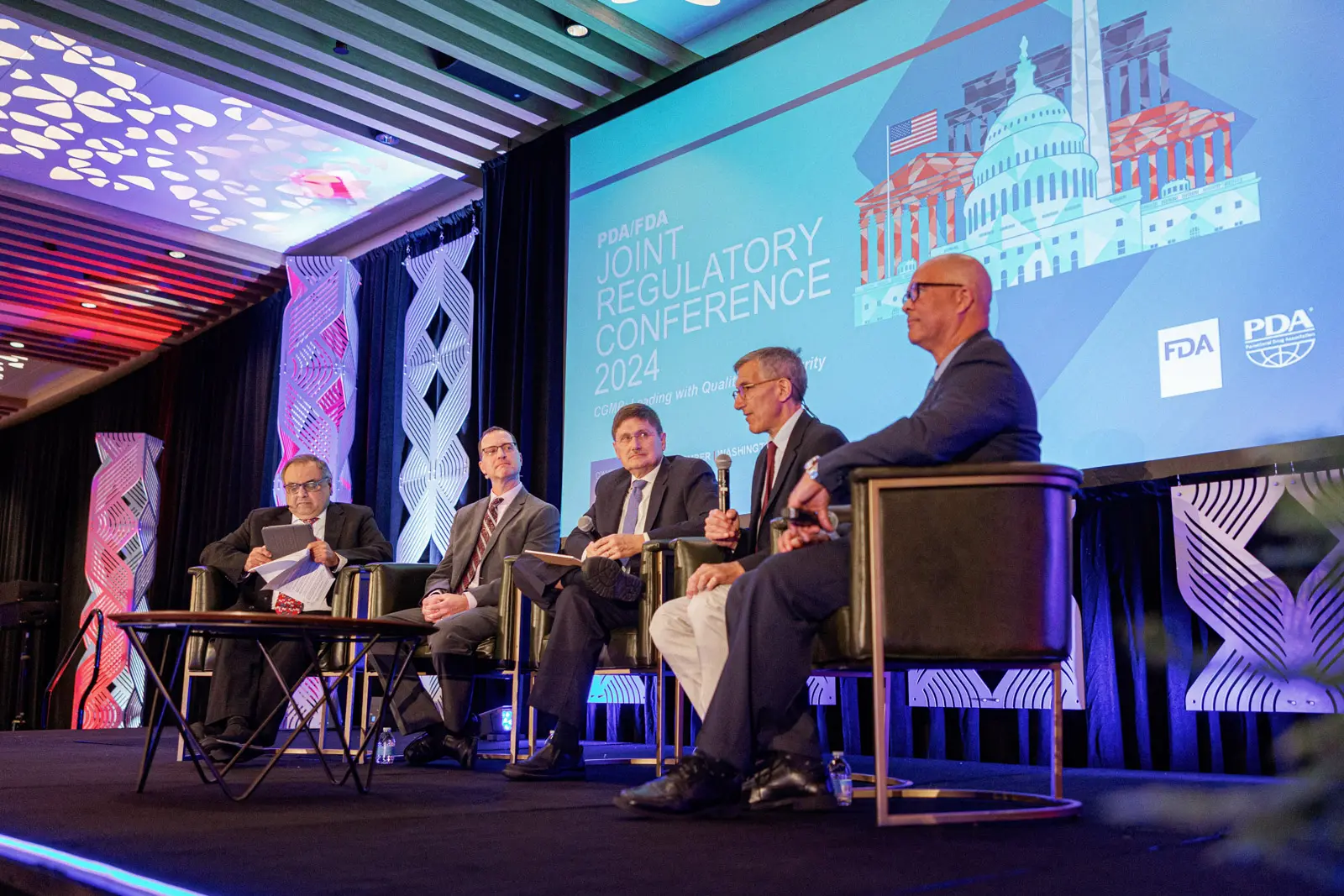 Panel discussion photographed on stage during a Washington DC conference