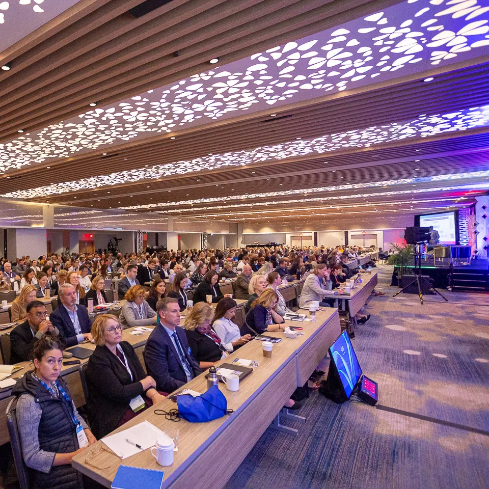 Side view of the FDA-PDA Annual Conference room with audience seated near the stage