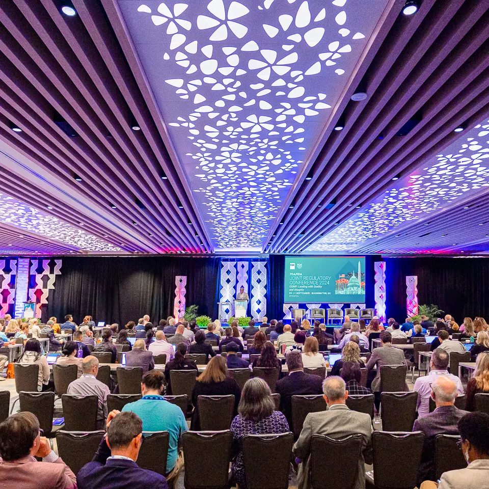 Wide keynote room view with audience, stage, and ceiling lighting at the FDA-PDA Annual Conference