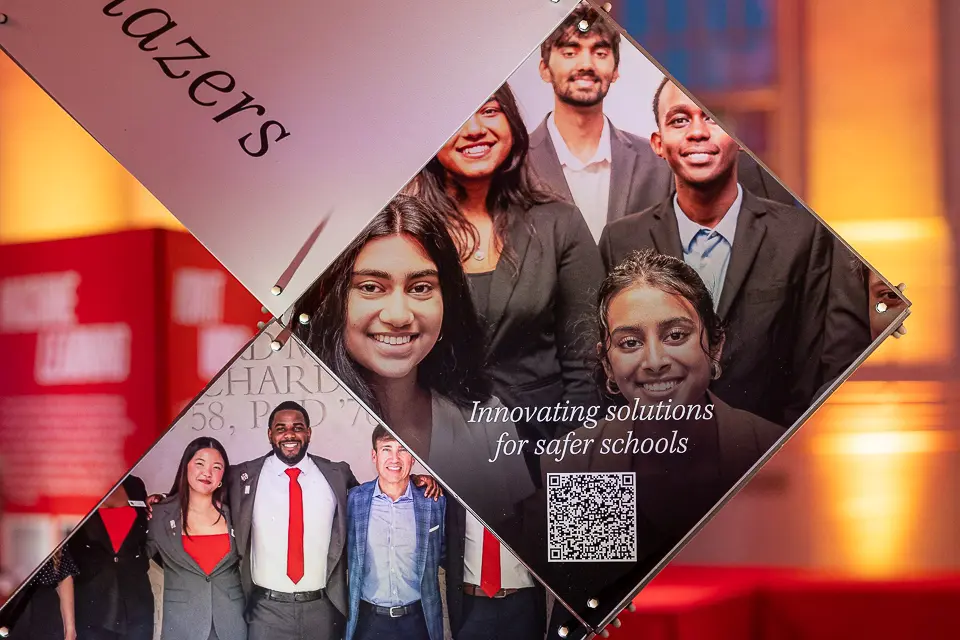 University of Maryland Forward campaign display with alumni portraits and QR code for guest engagement