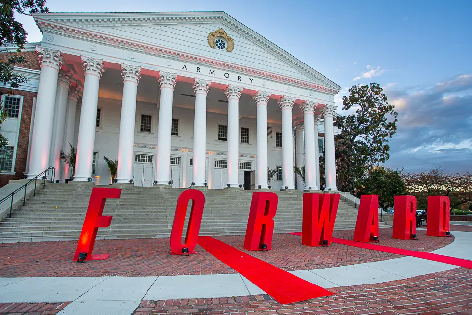 University of Maryland campus building exterior with large red FORWARD letters on the lawn
