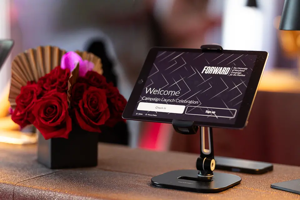 Welcome sign and red floral arrangement for the University of Maryland Forward campaign reception