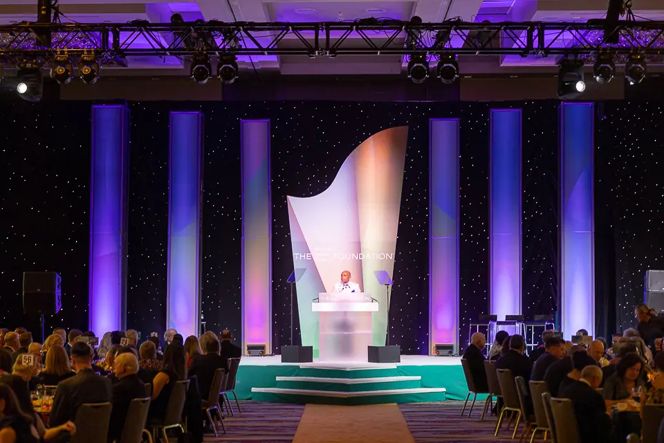Keynote speaker on the Herb Wegner Awards 2026 stage during the formal dinner program.