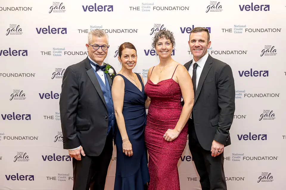 Four guests posing together at the Herb Wegner Awards 2026 Foundation step-and-repeat backdrop.