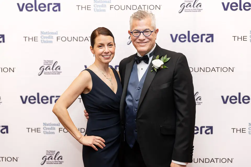 Couple portrait on the Herb Wegner Awards 2026 red carpet in front of Velera and Foundation sponsor branding.