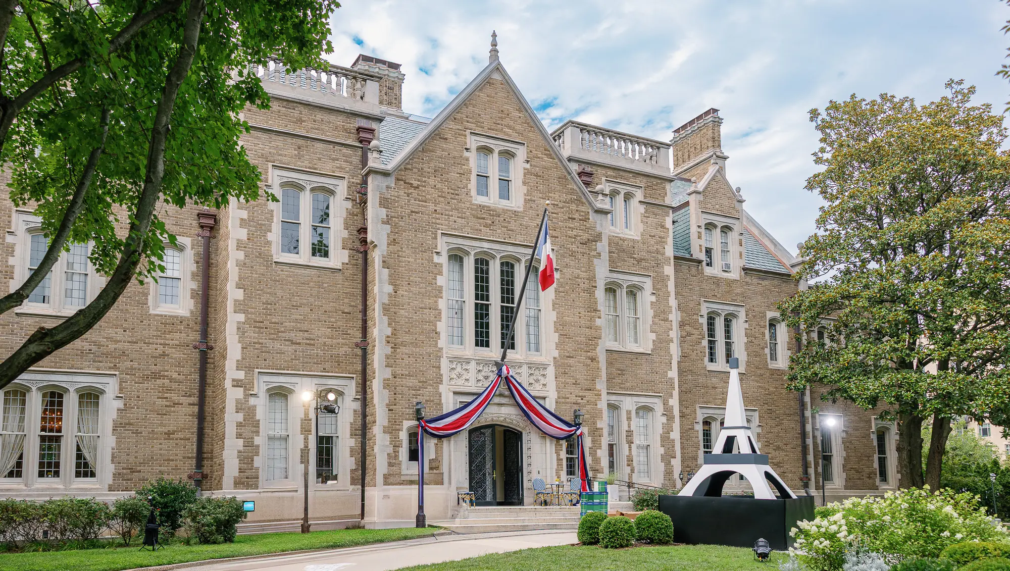 Historic Washington DC venue exterior with French flag and Paris-inspired decor