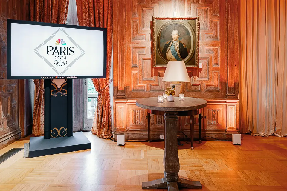 Paris in DC welcome sign inside a warm wood-paneled reception room