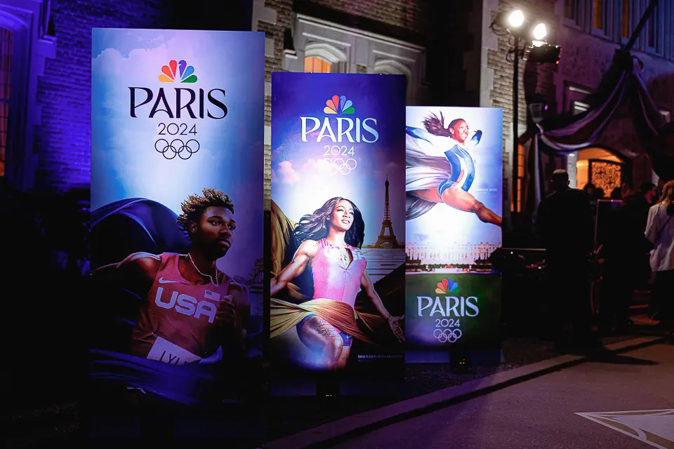 Paris-themed outdoor signage glowing with colorful evening lighting.