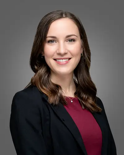 Professional corporate headshot of a woman in burgundy top photographed in Washington DC by District Pixel