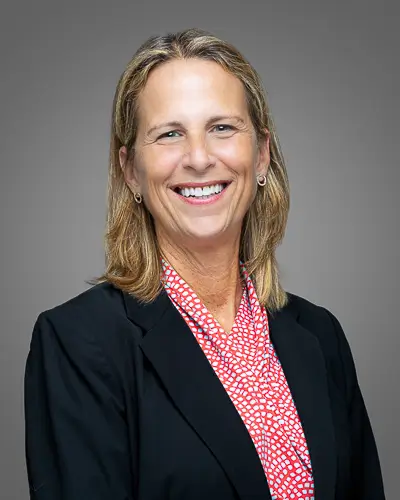 Professional business headshot of a woman on gray background photographed in Washington DC by District Pixel