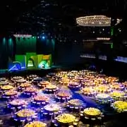 Corporate event photographer in Washington DC captures a black-tie dinner gala at The Anthem with illuminated round tables and stage lighting.