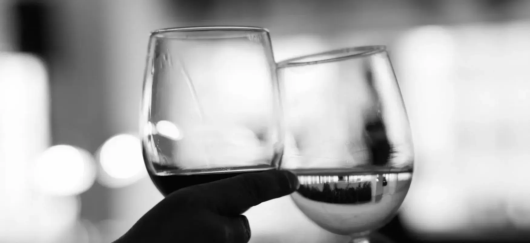 Black and white detail of guests toasting at a corporate reception in Washington DC photographed by District Pixel.