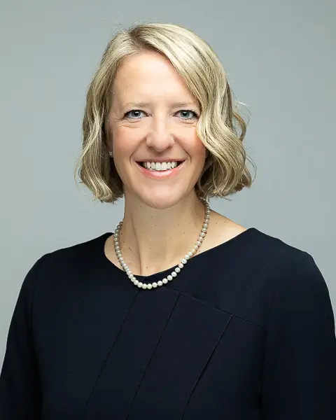 Professional corporate headshot of a woman in a blue blouse photographed in Washington DC by District Pixel